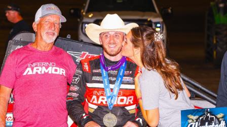 Kevin Thomas Jr. (middle) celebrates a $20,000 Haubstadt Hustler triumph on Saturday night with car owner Hank Byram (left) and a victory lane kiss from Kevin's wife, Whitney. (Jack Reitz Photo) (Video Highlights from FloRacing.com)